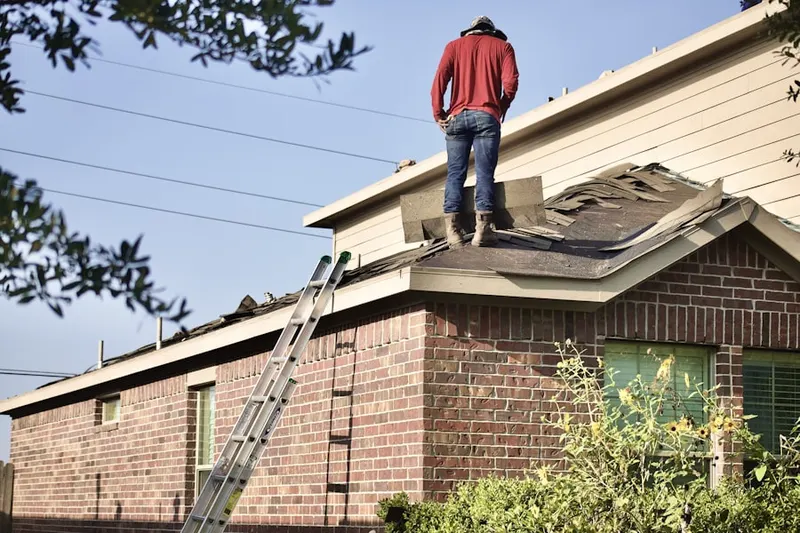 Professional roofer working on a residential roof in Energy Corridor
